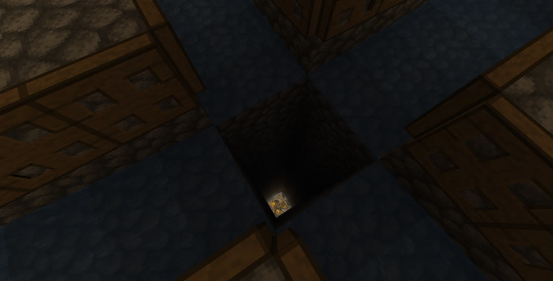 Looking down at the center of the spawning chamber. The water channels flow to the edge of a vertical shaft with lit campfires visible at the bottom.