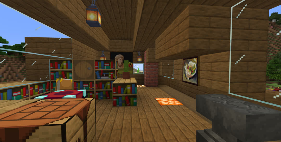 View from the top of the staircase, with the front of the house to the right. Just ahead are a crafting table on the left and an anvil in front of a window on the right. Past the crafting table is an enchanting table under a domed window and partially surrounded by bookshelves and a barrel. More lanterns light this room along with glowstone and a shroomlight in the floor. Straight ahead a potted cactus sits on the bookshelves, blocking the view of a painting on the far wall. Another painting hangs on the right wall between the windows. The brick chimney is in the far right corner.