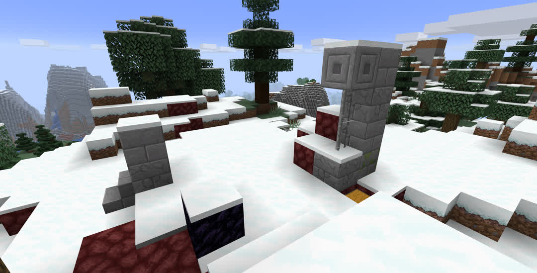 A mountaintop ruined nether portal, mostly covered by snow.