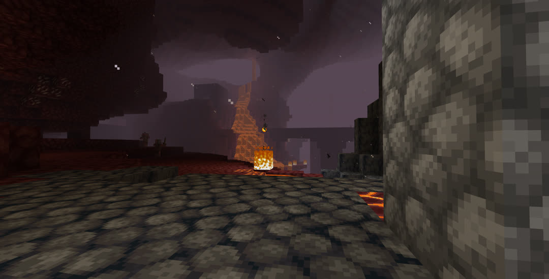 Looking across the Nether from behind some cobblestone.