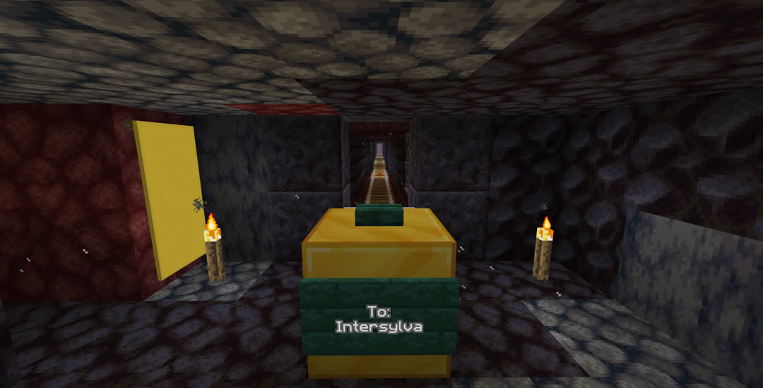 A small room at the Spawn end of the rail line. The tracks end at a gold block signed “To: Intersylva” and there is a yellow banner on the wall.