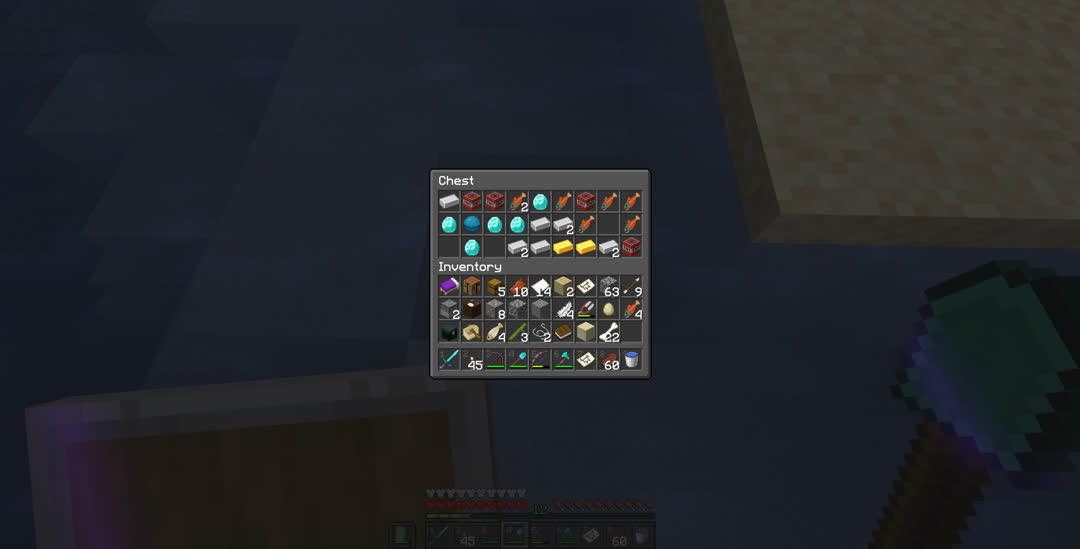 Chest containing nine iron ingots, four TNT, seven salmon, five diamonds, a heart of the sea, and two gold ingots.