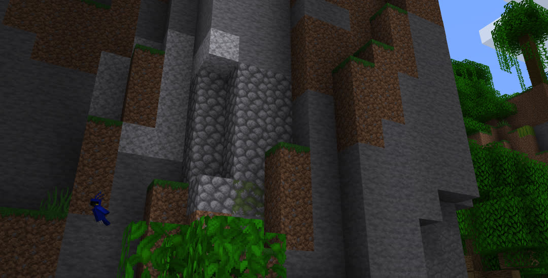 Cobblestone, some of it mossy, in the face of a jungle cliff.