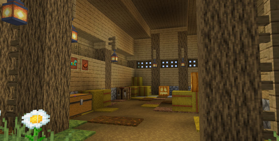 Interior of the stable. The floor is a mix of dirt, paths, podzol, and hay, with a few hay bales and jack‐o’‐lanterns strewn about. Diamond horse armor and a saddle are framed on the wall above a chest.