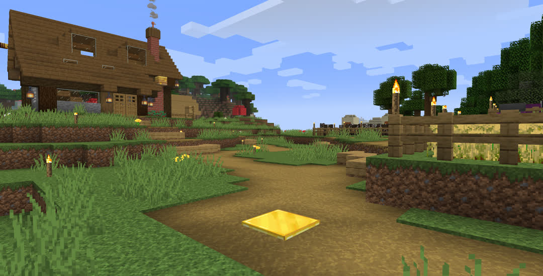 A gold block embedded in the ground in the middle of a dirt path around the field.