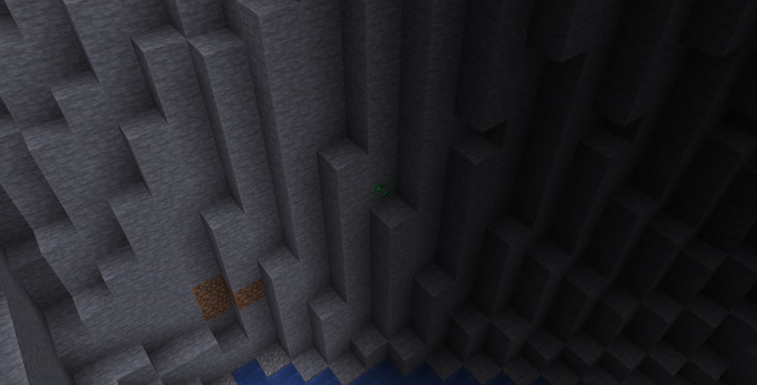 A single block of emerald ore in the shadows.