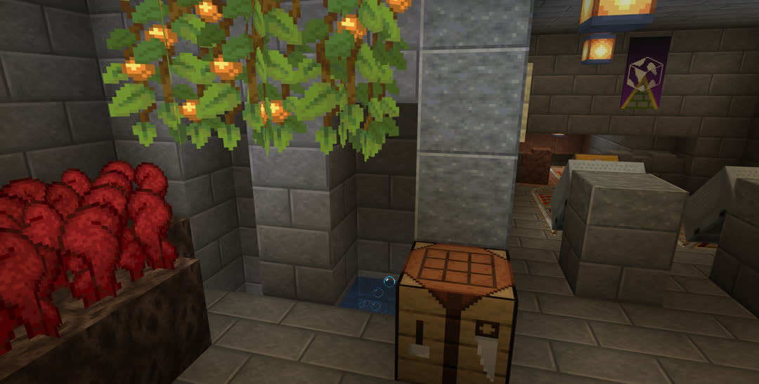 Top of a drop shaft and bubble column water elevator underneath some glow berries in the wall of a mostly stone brick room. There’s a small plot of nether wart to the left, a minecart station to the right, and a crafting table in the middle.