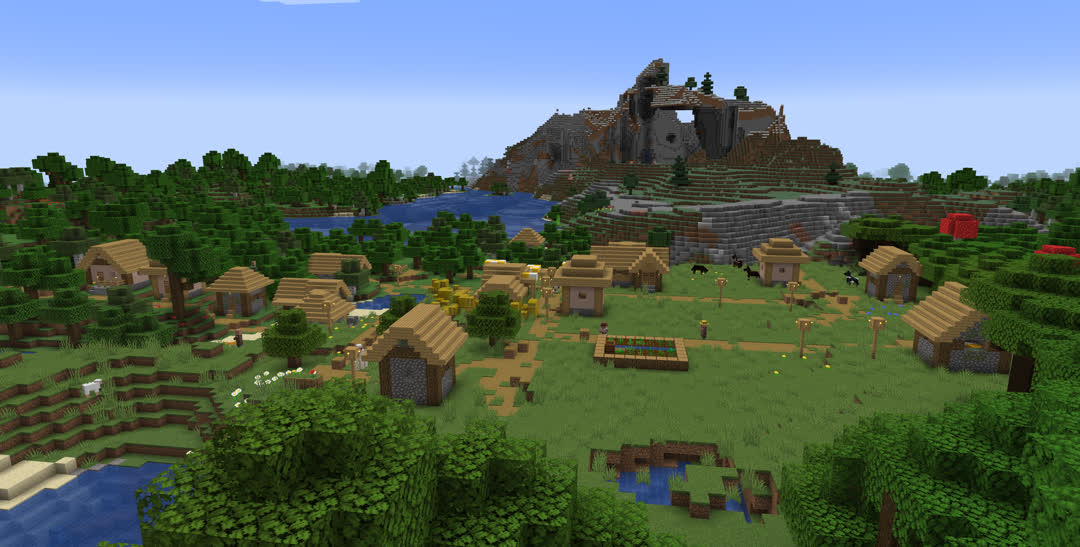 Looking over a plains village surrounded by forest and stony foothills.