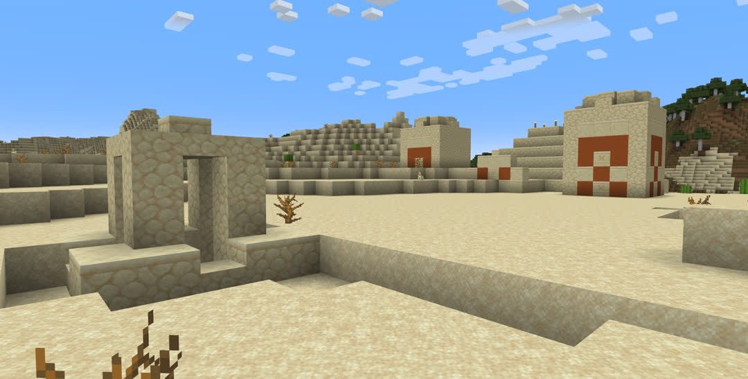 A half‐buried desert temple with a desert well not far from its façade.