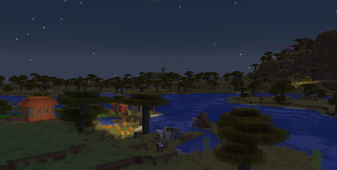 A riverside savanna village at dusk. A patch of jack‐o’‐lanterns lights the village outskirts. Across the river, at the base of a mountain with a few cherry trees peeking over among the acacias, another distant patch lights the savanna as well.